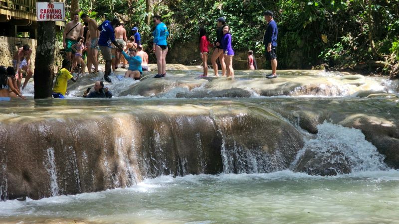 Tourists climbing Dunn's River Falls